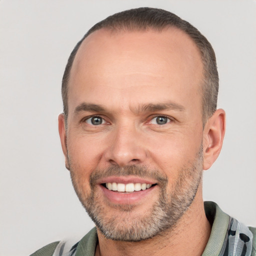 Joyful white adult male with short  brown hair and brown eyes