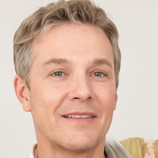 Joyful white adult male with short  brown hair and grey eyes