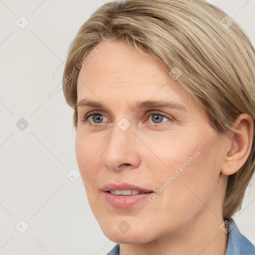 Joyful white adult female with medium  brown hair and blue eyes