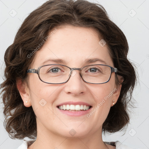 Joyful white adult female with medium  brown hair and blue eyes