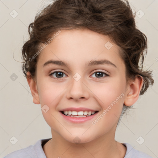 Joyful white child female with short  brown hair and brown eyes