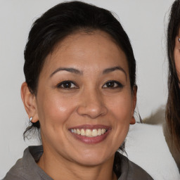 Joyful white adult female with medium  brown hair and brown eyes