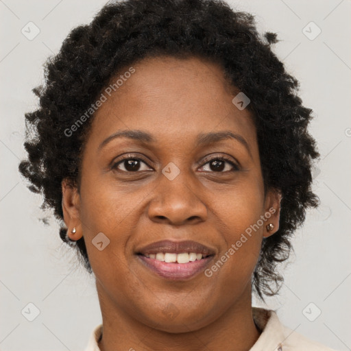 Joyful black adult female with short  brown hair and brown eyes