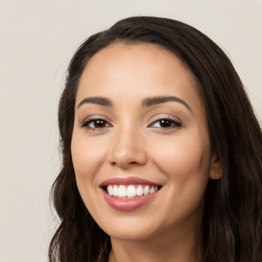 Joyful white young-adult female with long  black hair and brown eyes