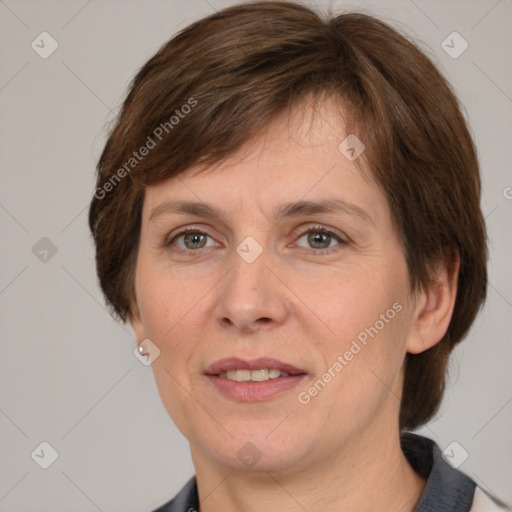 Joyful white adult female with medium  brown hair and grey eyes