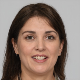 Joyful white adult female with medium  brown hair and grey eyes