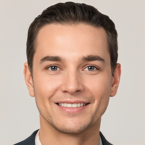 Joyful white young-adult male with short  brown hair and brown eyes