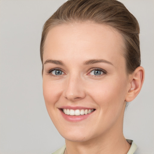 Joyful white young-adult female with short  brown hair and grey eyes