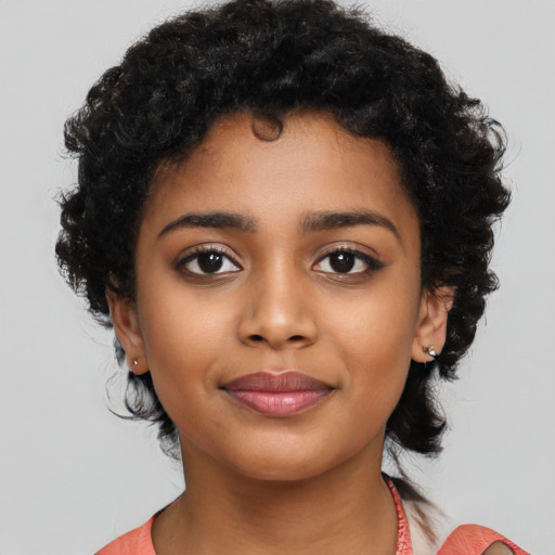Joyful latino child female with short  black hair and brown eyes