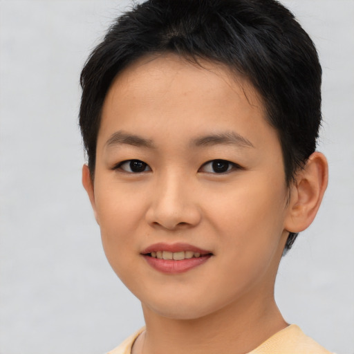Joyful asian young-adult female with short  brown hair and brown eyes