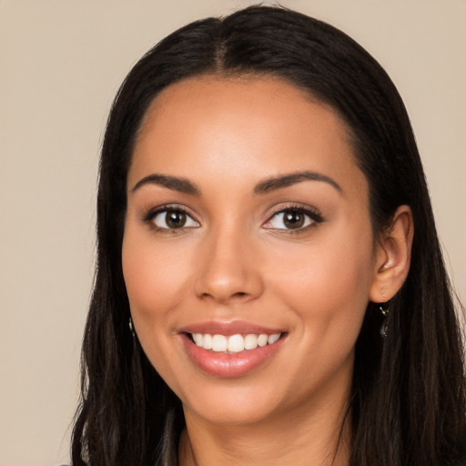 Joyful latino young-adult female with long  black hair and brown eyes