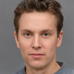 Joyful white adult male with short  brown hair and grey eyes