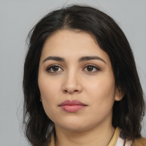 Neutral latino young-adult female with long  brown hair and brown eyes