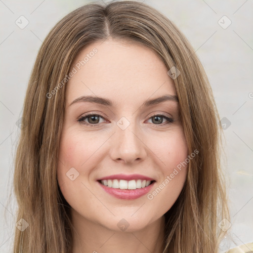 Joyful white young-adult female with long  brown hair and green eyes