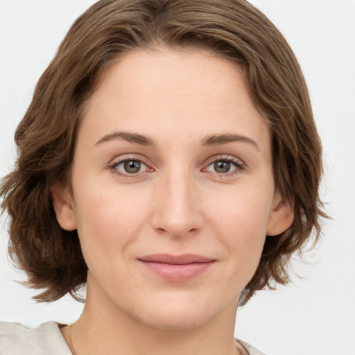 Joyful white young-adult female with medium  brown hair and green eyes