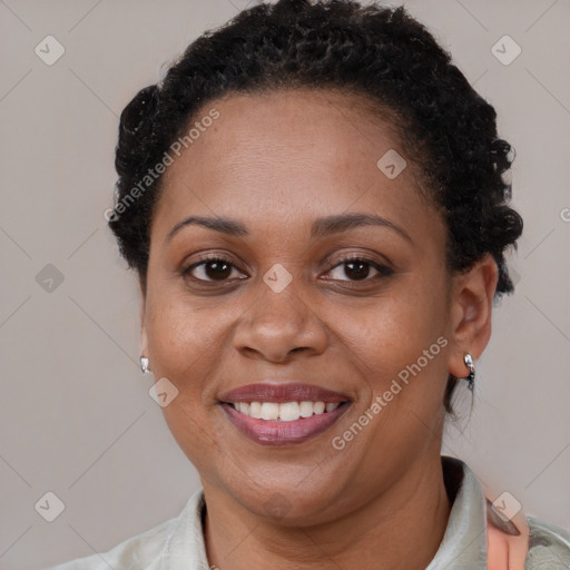 Joyful black adult female with short  brown hair and brown eyes