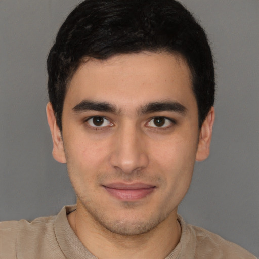 Joyful latino young-adult male with short  brown hair and brown eyes