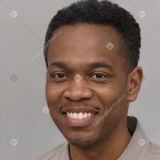 Joyful black young-adult male with short  black hair and brown eyes