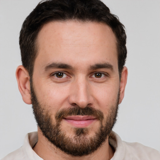 Joyful white young-adult male with short  brown hair and brown eyes