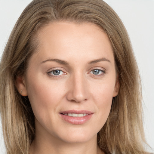 Joyful white young-adult female with long  brown hair and grey eyes