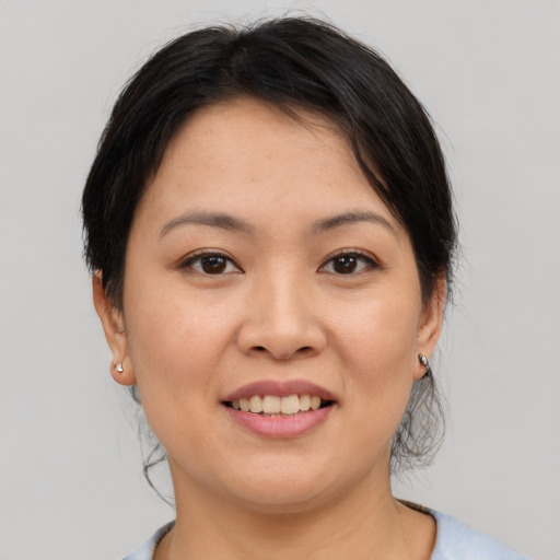 Joyful asian young-adult female with short  brown hair and brown eyes