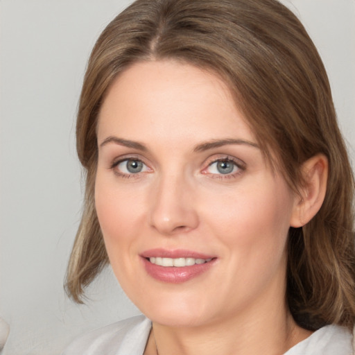 Joyful white young-adult female with medium  brown hair and blue eyes