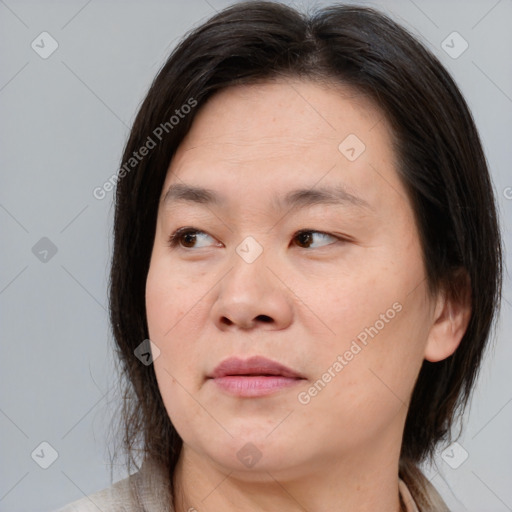 Joyful white adult female with medium  brown hair and brown eyes