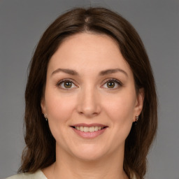 Joyful white young-adult female with medium  brown hair and green eyes