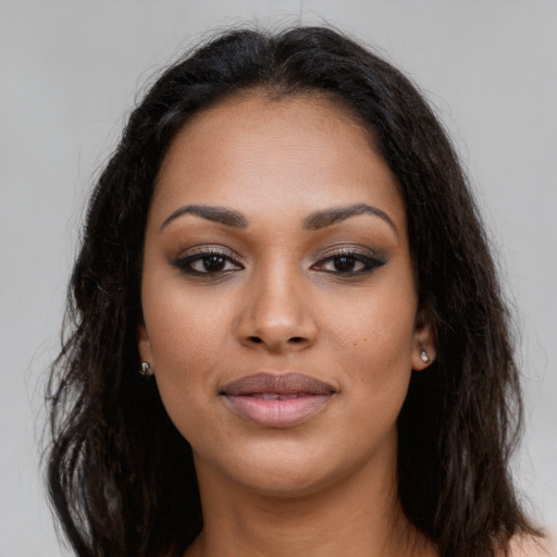Joyful latino young-adult female with long  brown hair and brown eyes