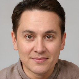 Joyful white adult male with short  brown hair and brown eyes