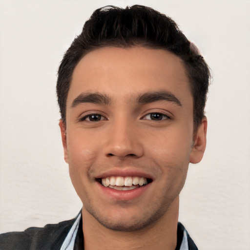 Joyful white young-adult male with short  black hair and brown eyes