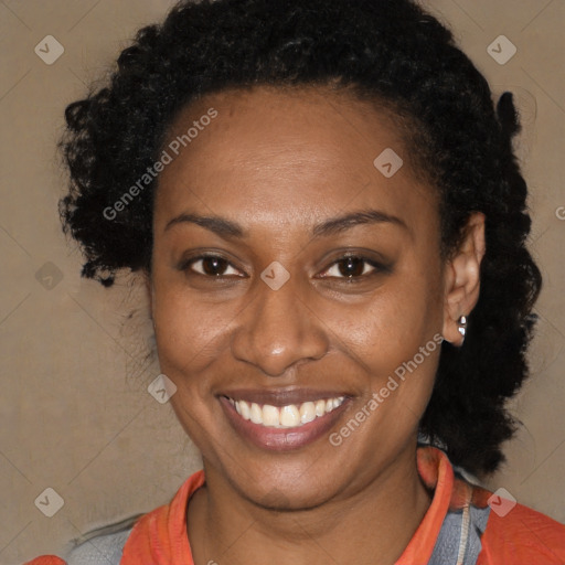 Joyful black adult female with short  brown hair and brown eyes