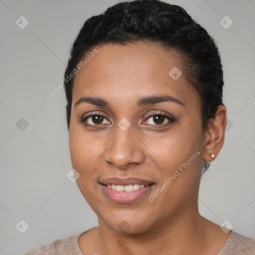 Joyful black young-adult female with short  black hair and brown eyes