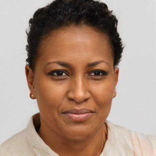 Joyful black young-adult female with short  brown hair and brown eyes