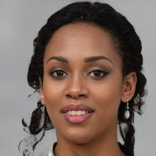 Joyful black young-adult female with medium  black hair and brown eyes