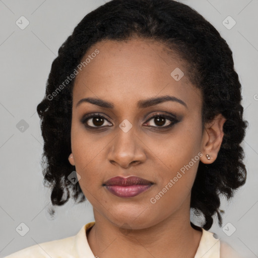 Joyful black young-adult female with medium  black hair and brown eyes