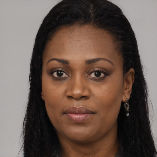 Joyful black young-adult female with long  black hair and brown eyes