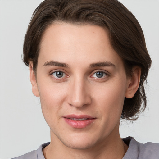 Joyful white young-adult female with short  brown hair and grey eyes