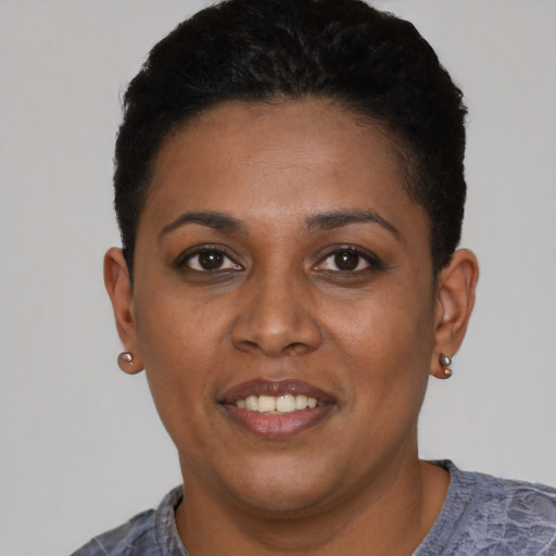 Joyful black young-adult female with short  black hair and brown eyes