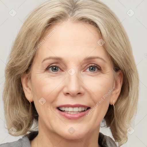 Joyful white adult female with medium  brown hair and grey eyes