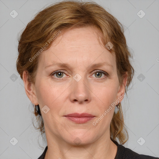 Joyful white adult female with medium  brown hair and blue eyes