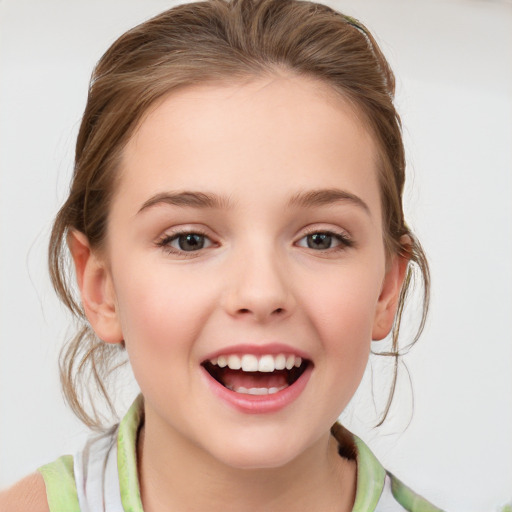 Joyful white child female with medium  brown hair and grey eyes