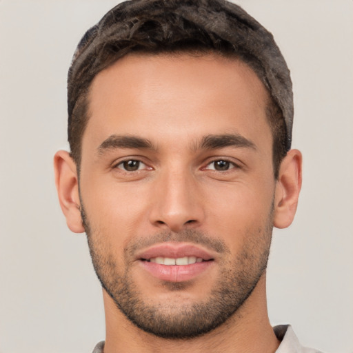 Joyful white young-adult male with short  brown hair and brown eyes