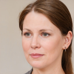 Joyful white adult female with medium  brown hair and blue eyes