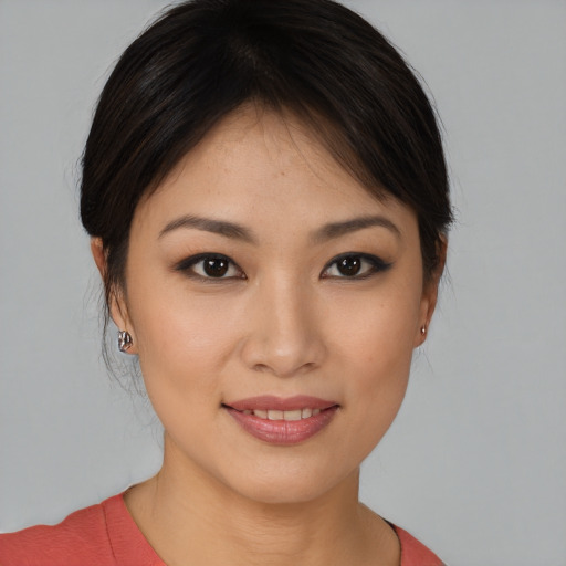 Joyful asian young-adult female with medium  brown hair and brown eyes