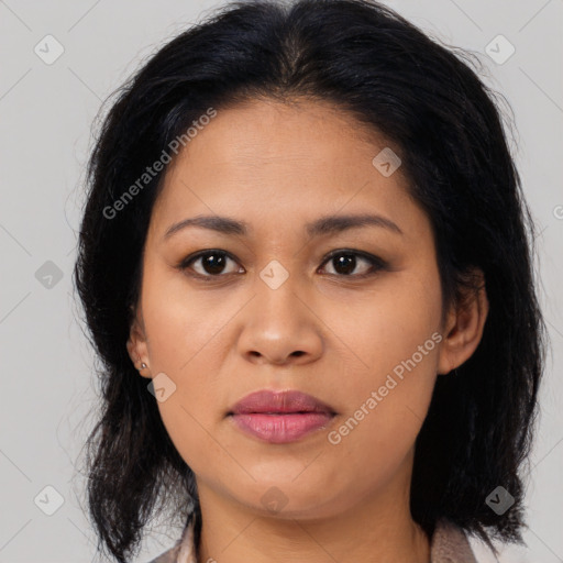 Joyful latino young-adult female with medium  brown hair and brown eyes