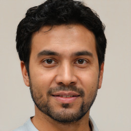 Joyful white young-adult male with short  black hair and brown eyes