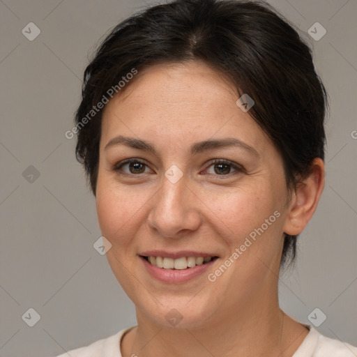 Joyful white adult female with short  brown hair and brown eyes