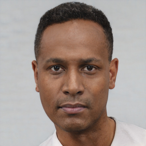 Neutral black young-adult male with short  black hair and brown eyes
