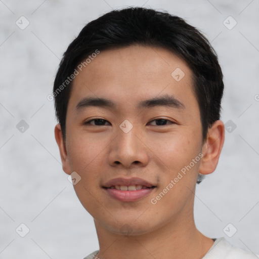 Joyful asian young-adult male with short  black hair and brown eyes